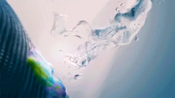 Abstract blue, teal and pink fluid forms twisting into a circular composition.