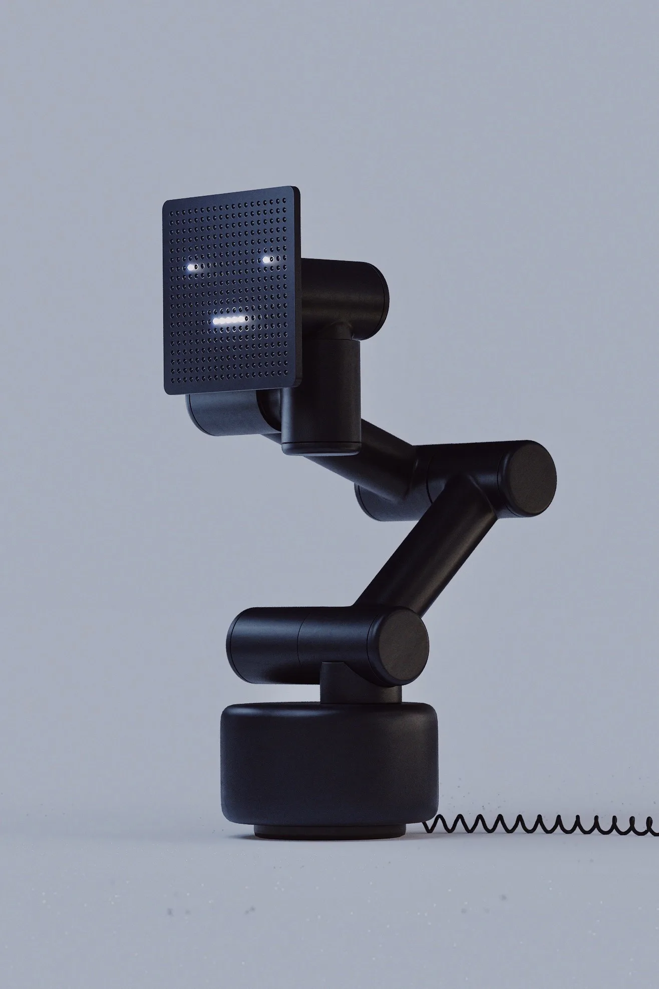 Black robotic arm holding a small dark cube against a light grey background.