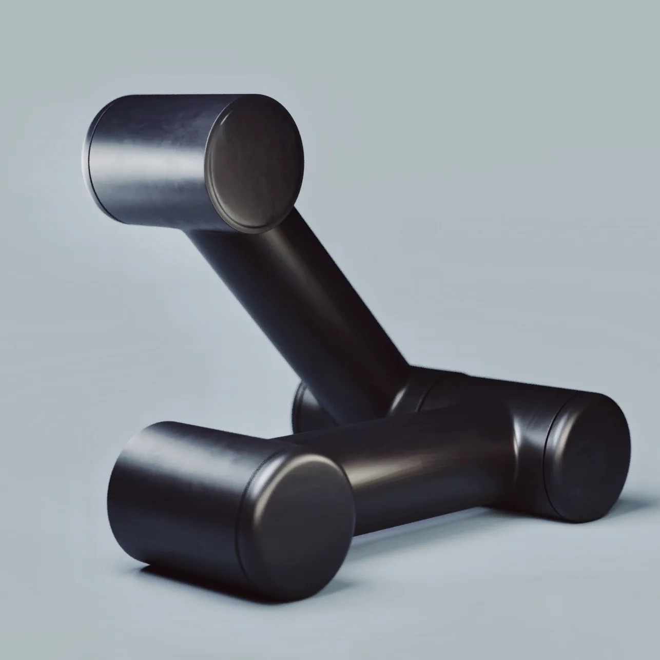 Close-up of a black articulated robotic arm against a pale background.